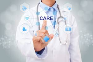 Doctor holds index finger up, pointing to the word “Care” to represent direct primary care services