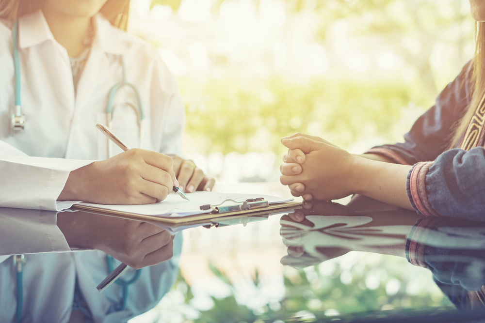 What Happens During a Muscle Testing Appointment? 1 Functional medicine provider talking to a patient about muscle testing in Lone Tree